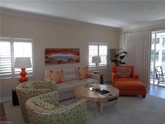 Living room featuring crown molding and baseboards