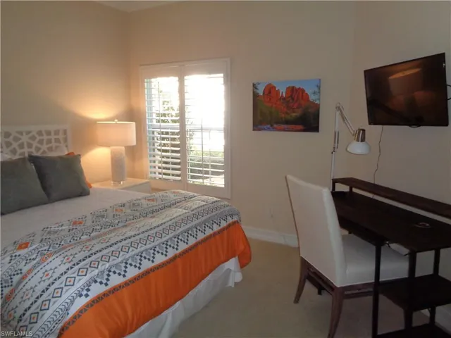 Carpeted bedroom with baseboards