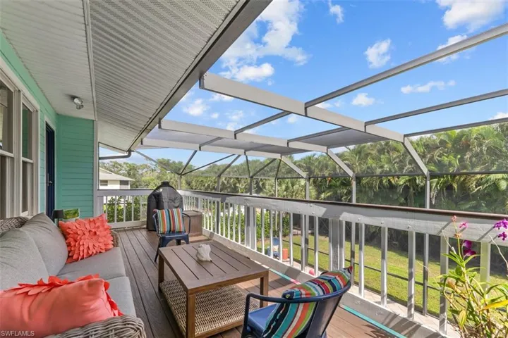 Wooden terrace featuring glass enclosure, a sunroom, and a grill