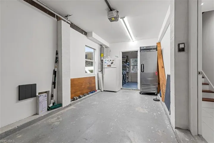 Garage #1 featuring freestanding refrigerator and a garage door opener