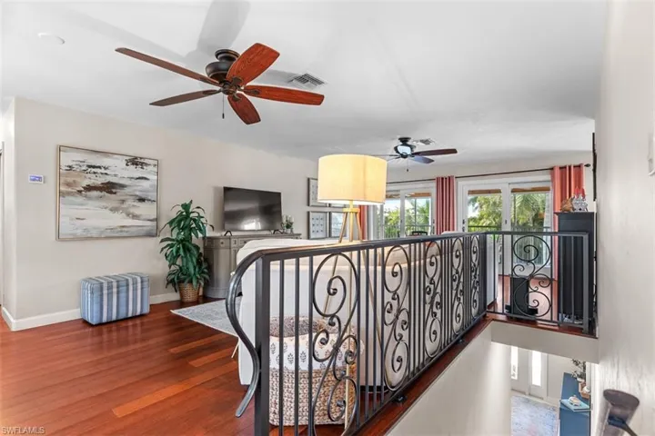Stairs featuring wood finished floors and baseboards
