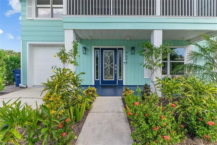 Doorway to property with a garage
