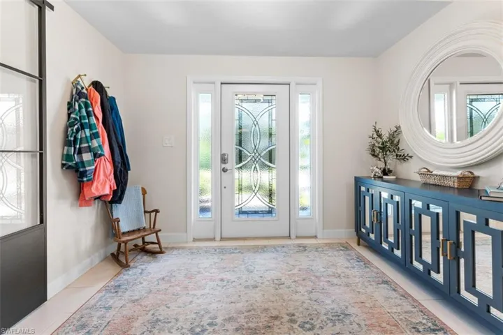 Entrance foyer featuring plenty of natural light and light tile patterned floors