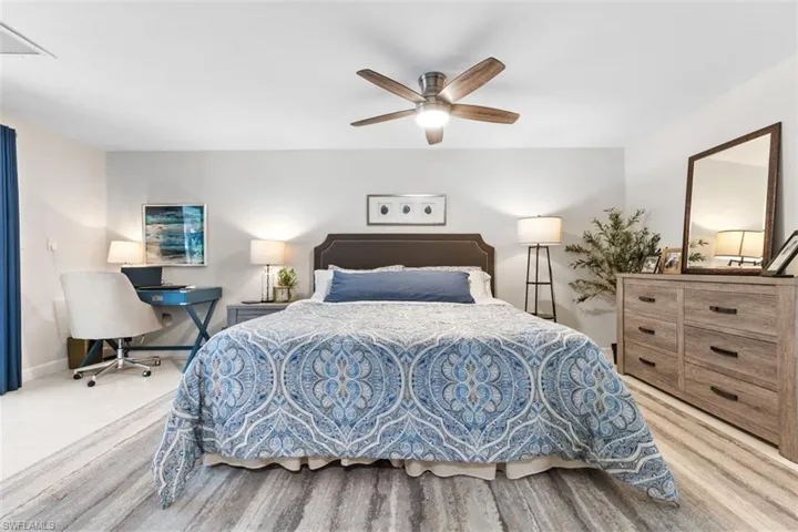 Master Bedroom featuring wood finished floors, a ceiling fan, and a desk