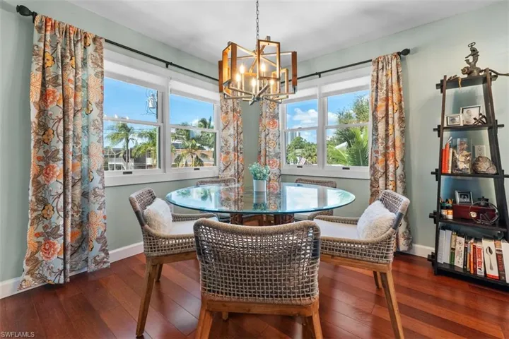 Dining space featuring a chandelier and dark wood-type flooring