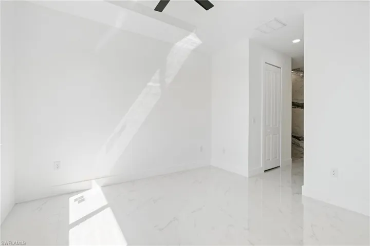 Additional living space featuring recessed lighting, baseboards, marble finish floor, and ceiling fan