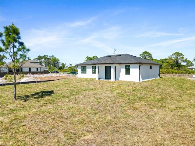 Rear view of house featuring a yard