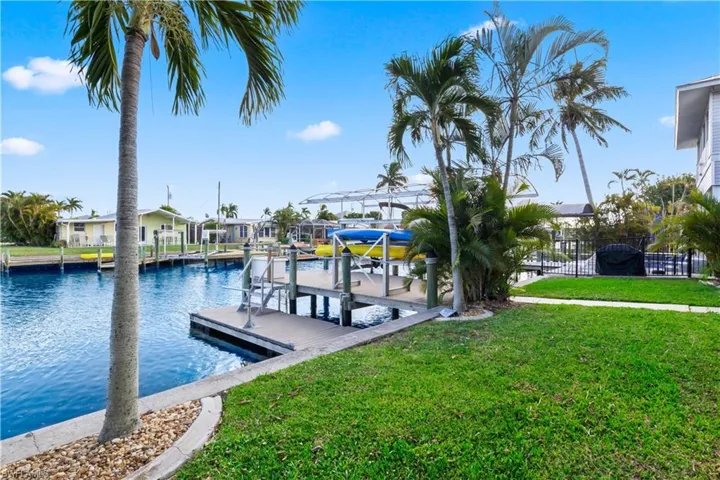 Scenic canal frontage with a private boat dock and lift, perfect for Gulf-access boating, fishing, or relaxing by the water.