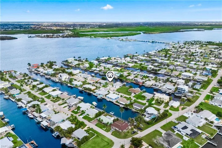 Stunning aerial showcasing canals, homes, and nearby open waters, emphasizing space, privacy, and boating opportunities.