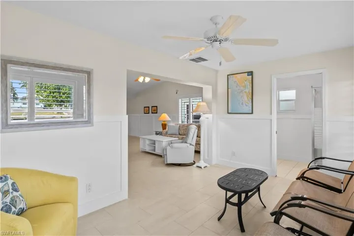 Sunroom with ensuite bath provides seamless functionality for guests, hobbies, or additional living space.