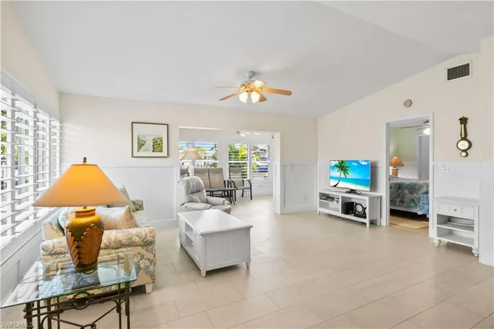 Large windows with plantation shutters fill the rooms with natural light while offering adjustable shade for comfort.