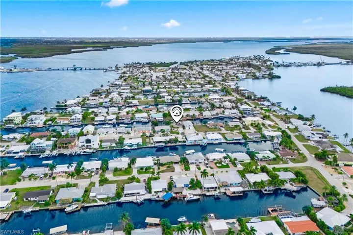 Breathtaking aerial view showcasing the entire neighborhood, canal system, and direct access to open waters — highlighting the home’s prime location for boating and waterfront living.