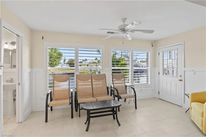 Light-filled sunroom ideal as an office, reading nook, or additional living space; flexible enough to convert into a third bedroom including a bathroom. Side doors provide access to the patio and waterfront views.