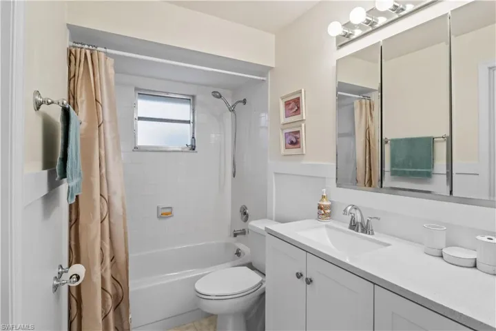 Primary bathroom designed for ease and style, featuring a combo tub/shower and contemporary touches.