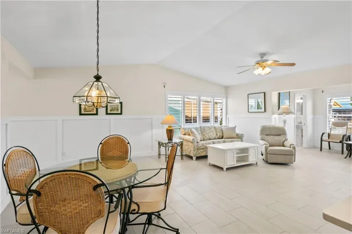 Comfortable dining space adjacent to the kitchen and living area, perfect for family meals or hosting guests with waterfront views nearby.
