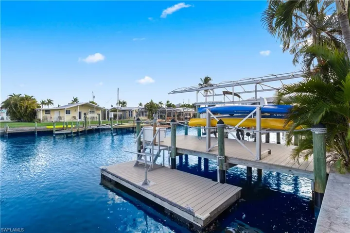 Private dock with boat lift offering quick access to open water and the Gulf of Mexico.