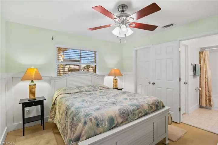 Spacious retreat with large windows overlooking the canal, en-suite bathroom, and ample closet space.