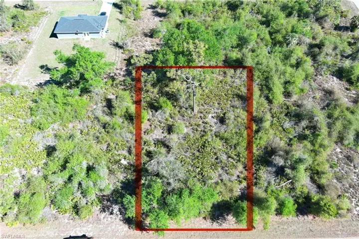 Aerial view of property and surrounding area with property parcel outlined