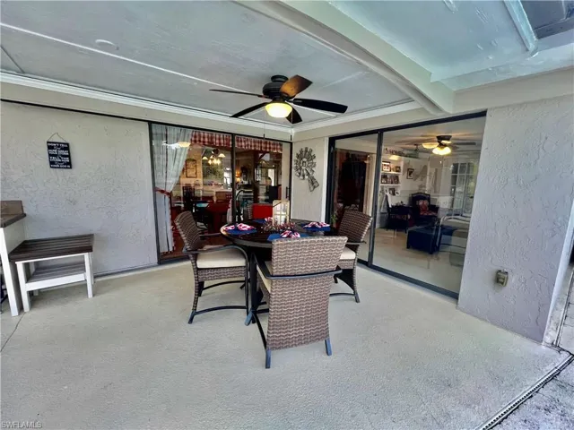 Covered patio overlooking the pool area with built in cabinets and counterspace