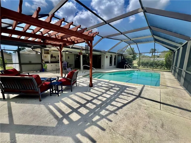 Screen enclosed in ground pool with Pergola.