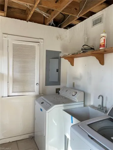 Inside Laundry and Storage Room with Wash Sink. Current photo.