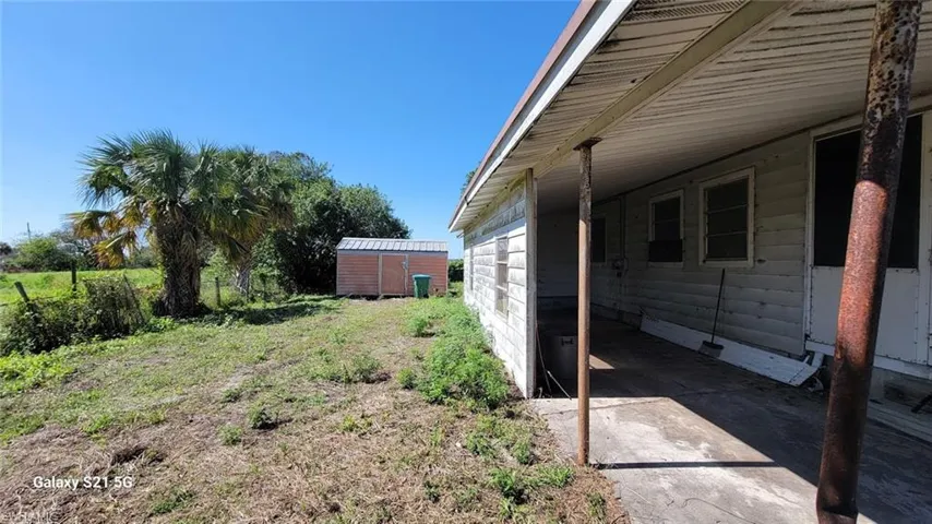 View of yard with a shed and a carport