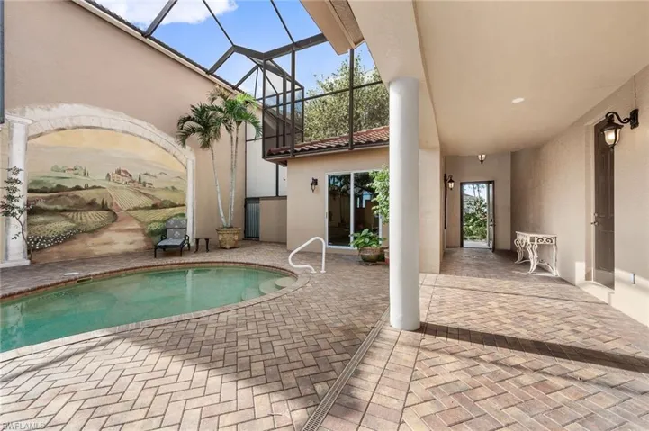View of pool with a lanai and a patio area