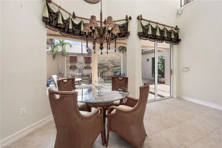 Tiled dining area featuring a notable chandelier
