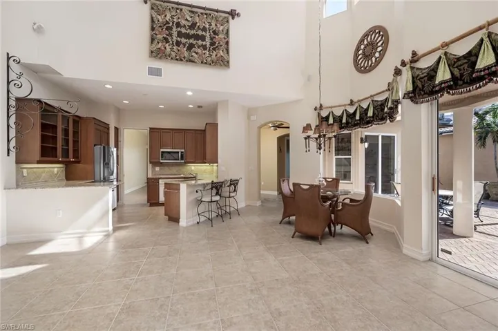 Dining space featuring a high ceiling and light tile patterned floors