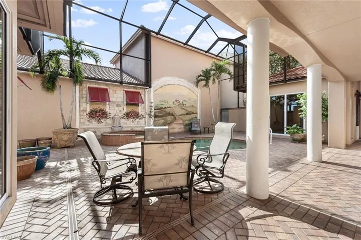 View of patio featuring glass enclosure