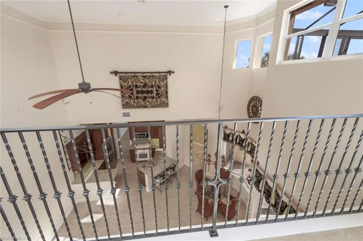 Staircase featuring carpet flooring, ceiling fan, and crown molding