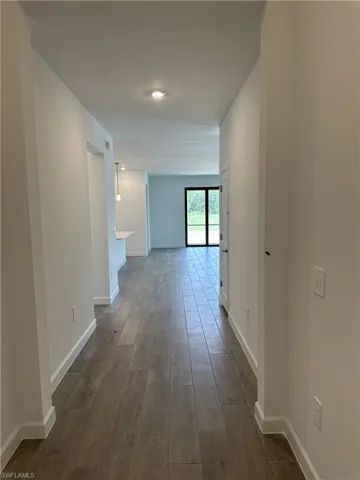 Hall with hardwood / wood-style flooring