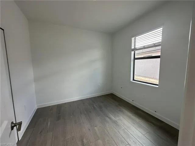 Unfurnished room with hardwood / wood-style floors