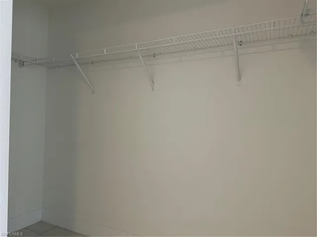 Walk in closet with light tile patterned floors