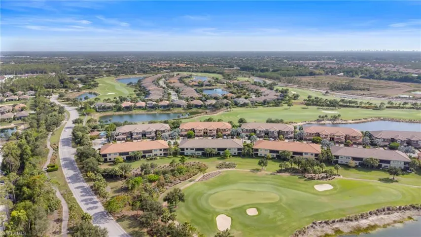 Aerial view of property's location with a golf club, nearby suburban area, and a large body of water