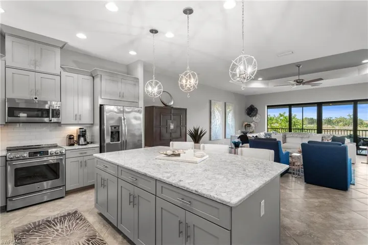 Kitchen with appliances with stainless steel finishes, gray cabinetry, decorative backsplash, ceiling fan, and recessed lighting