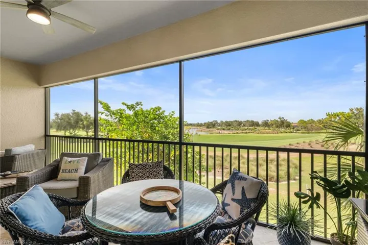 Sunroom featuring ceiling fan and golf course view