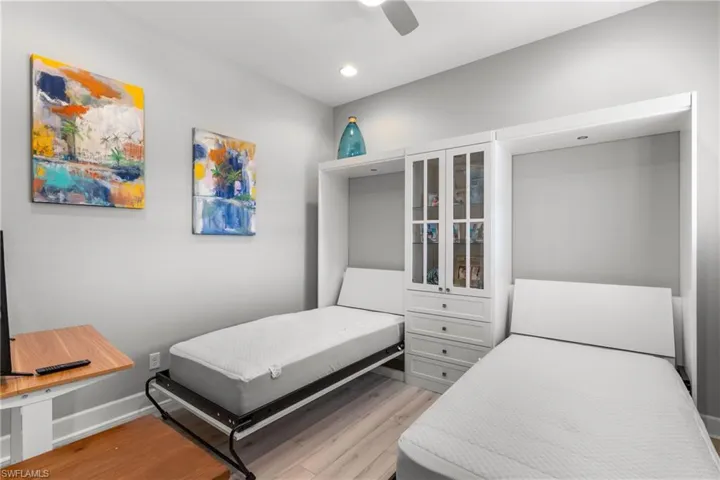 Bedroom featuring light wood-style flooring, recessed lighting, ceiling fan, and baseboards