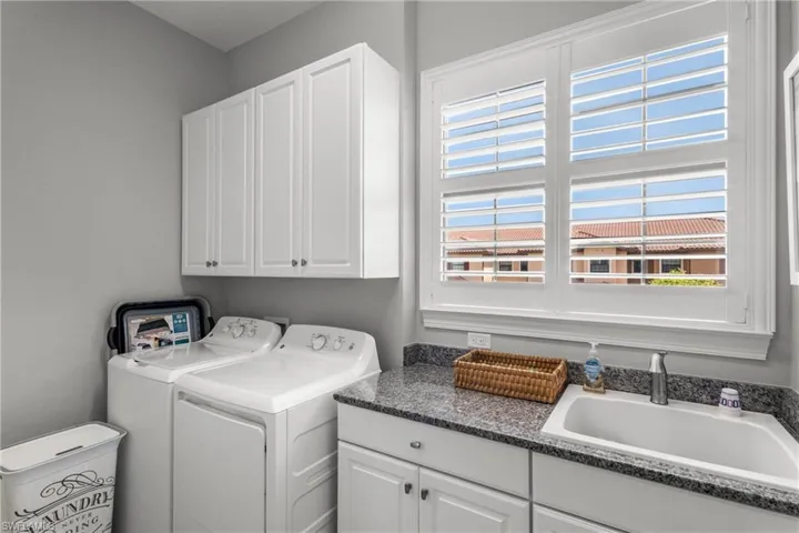 Washroom with cabinet space and independent washer and dryer