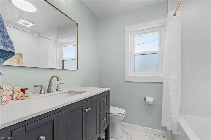 Full bathroom with vanity, toilet, and shower / bathtub combination
