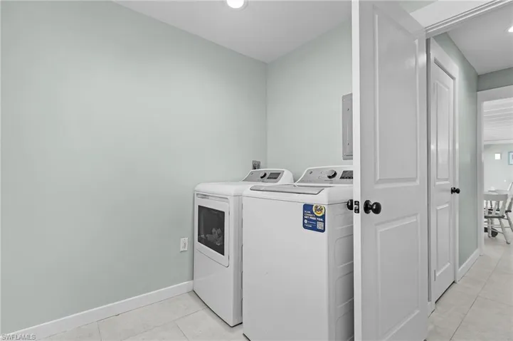 Laundry Room featuring washer and dryer and light tile patterned floors