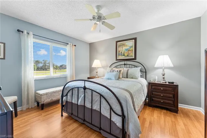 Bedroom with ceiling fan, baseboards, and light wood-style floors