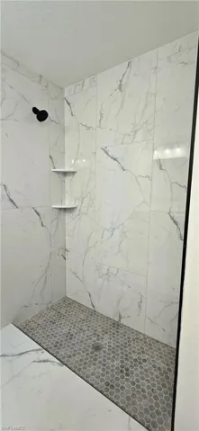 Bathroom featuring tiled shower
