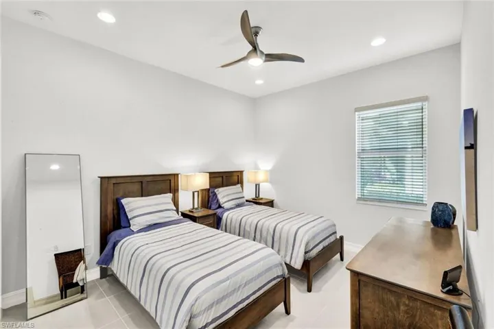 Bedroom with a ceiling fan, recessed lighting, and light tile patterned floors