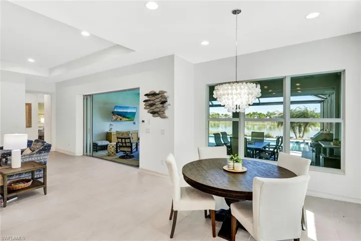 Dining space with hanging lights and a tray ceiling