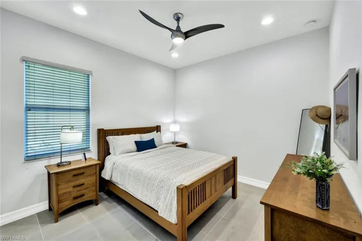 Bedroom with ceiling fan, recessed lighting, and light tile patterned floors