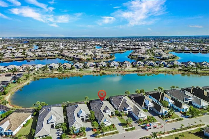 Aerial perspective of suburban area featuring a nearby body of water