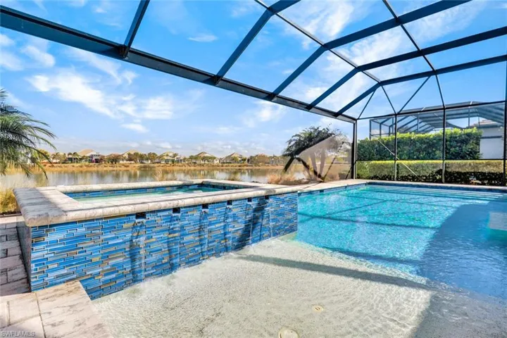 Integrated pool / hot tub featuring a lanai, a sunroom, a water view, and a residential view