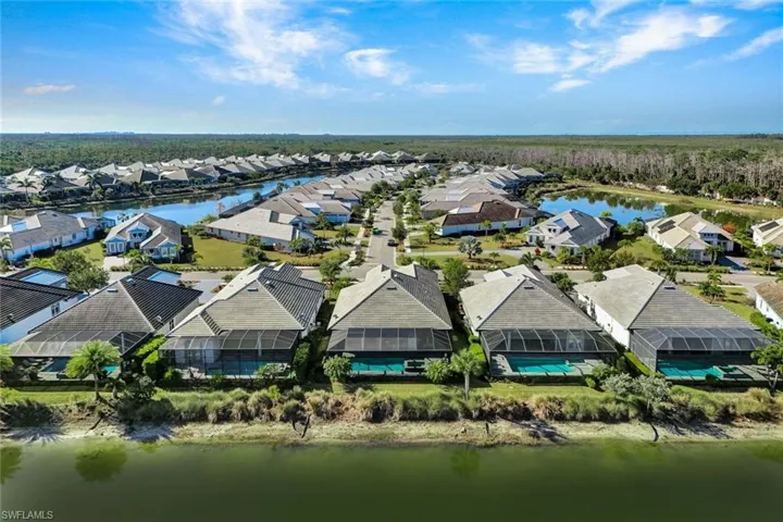 Aerial view of residential area featuring a nearby body of water