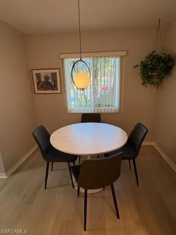 Dining room with wood finished floors and baseboards